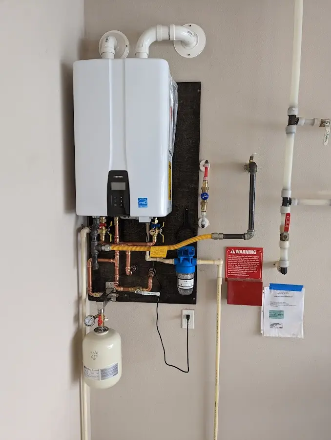 Professional plumber installing copper piping in a Burbank home